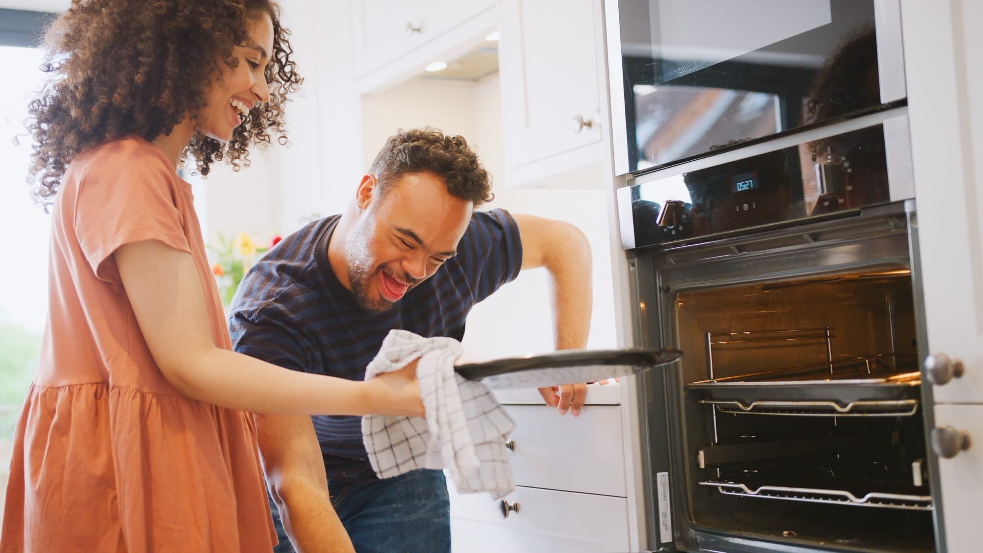 Taking a tray out of the oven together